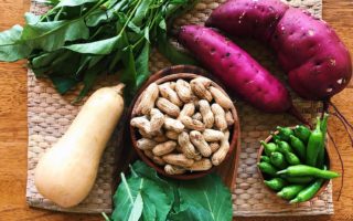 swee potatoes, squash, greens, peanuts laid out on bamboo mat