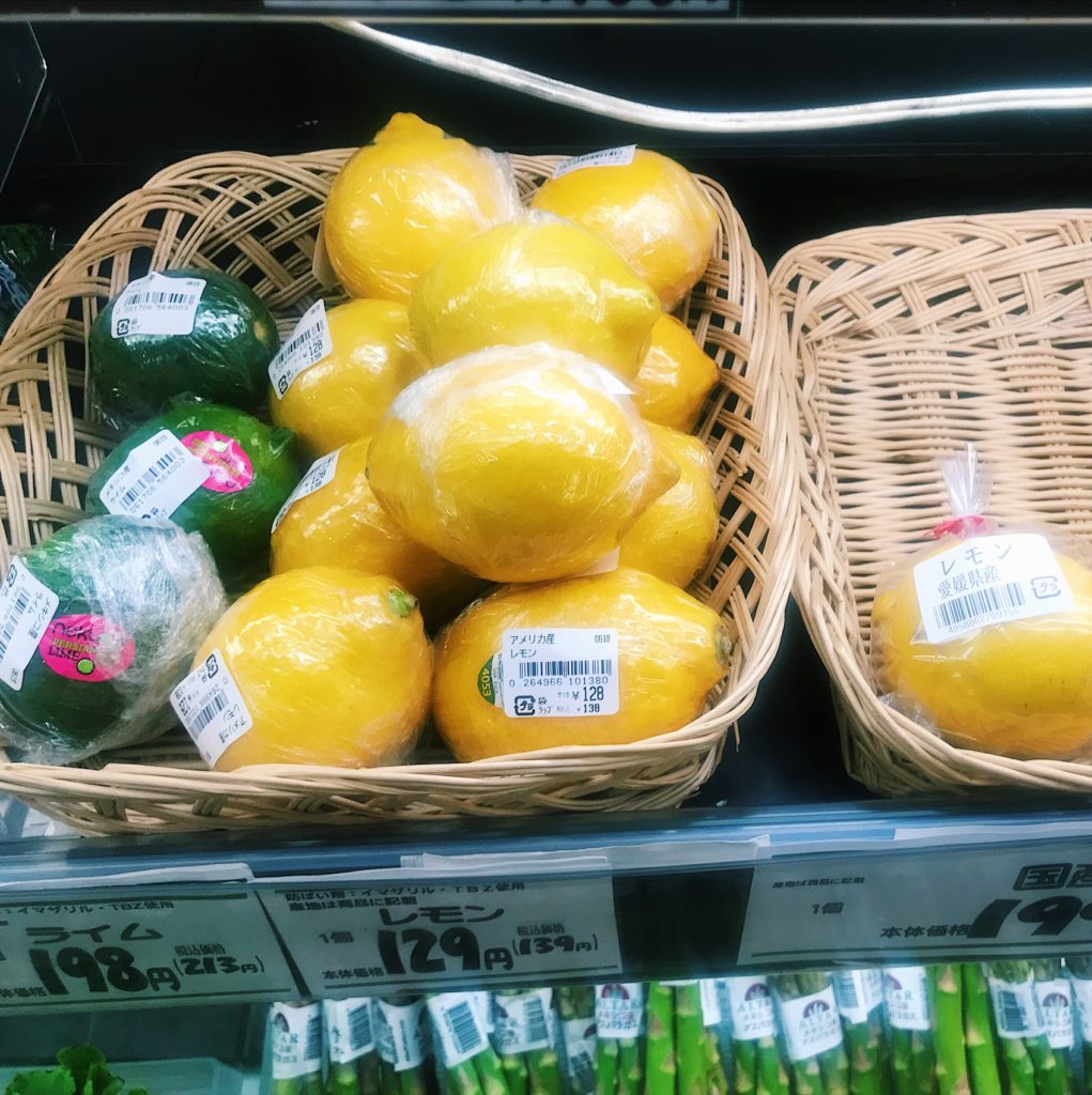 lemons on store shelf wrapped in cling wrap 