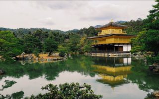 golden pavilion overlooking pond and zen gardens